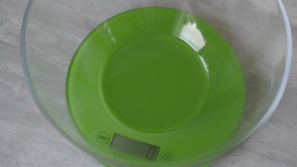 Woman hands put flour into a transparent bowl on the electronic scales for making dough. — Stock Video