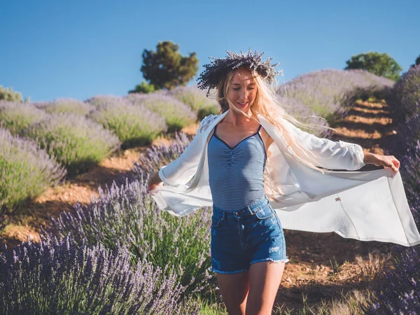 Blonde caucasian woman enjoying life in lavender field