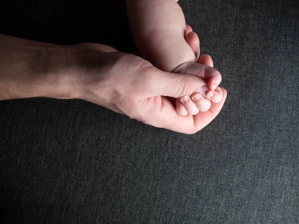 Closeup of father holding baby hand fathers day — Stock Photo, Image