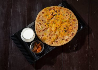 Indian breakfast dish paneer paratha serve with curd or chutney