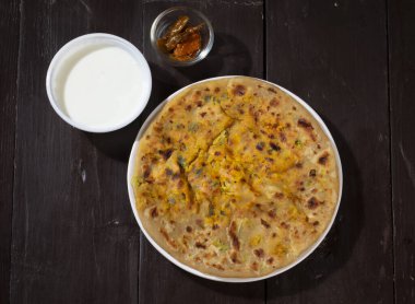Indian breakfast dish paneer paratha serve with curd or chutney