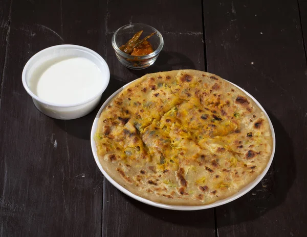 Indian breakfast dish paneer paratha serve with curd or chutney