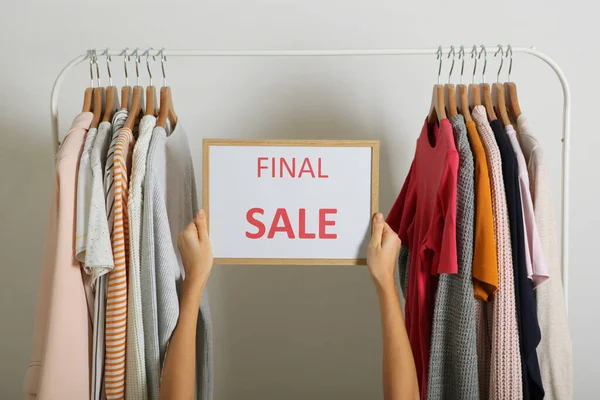 Clothes on the rail and a sale sign. Final sale, discounts