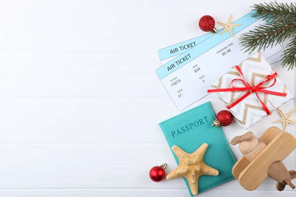 plane tickets and Christmas accessories on a colored background view from above. Christmas holidays, vacation