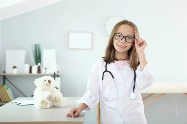 Schattig meisje in goed humeur speelt arts — Stockfoto