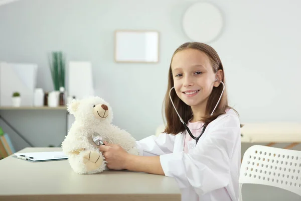 Schattig meisje in goed humeur speelt arts — Stockfoto