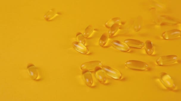 Omega 3 tobolky na oranžovém pozadí. Doplňky stravy, vitamíny. — Stock video