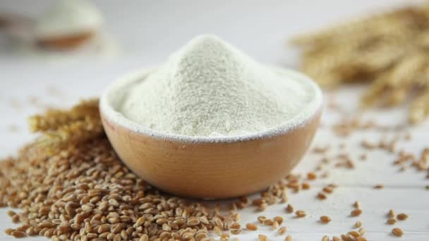 Wheat flour, wheat grains and spikelets on a wooden table. Sift flour. — Stock Video