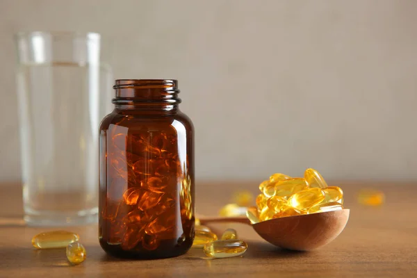 Omega 3 capsules on the table close-up with place for text.