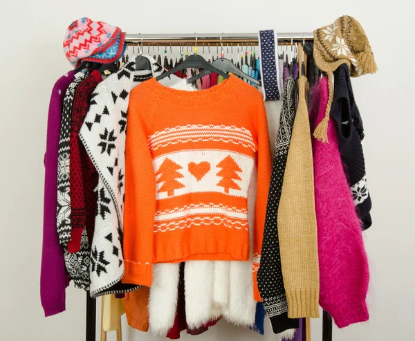 Cute sweaters displayed on a rack.