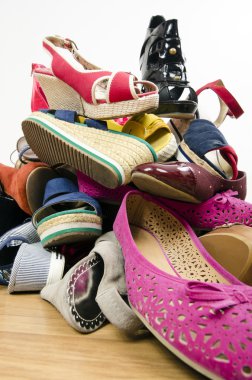 Close up on big pile of colorful woman shoes. clipart