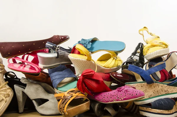 Close up on big pile of colorful woman shoes. — Stock Photo, Image