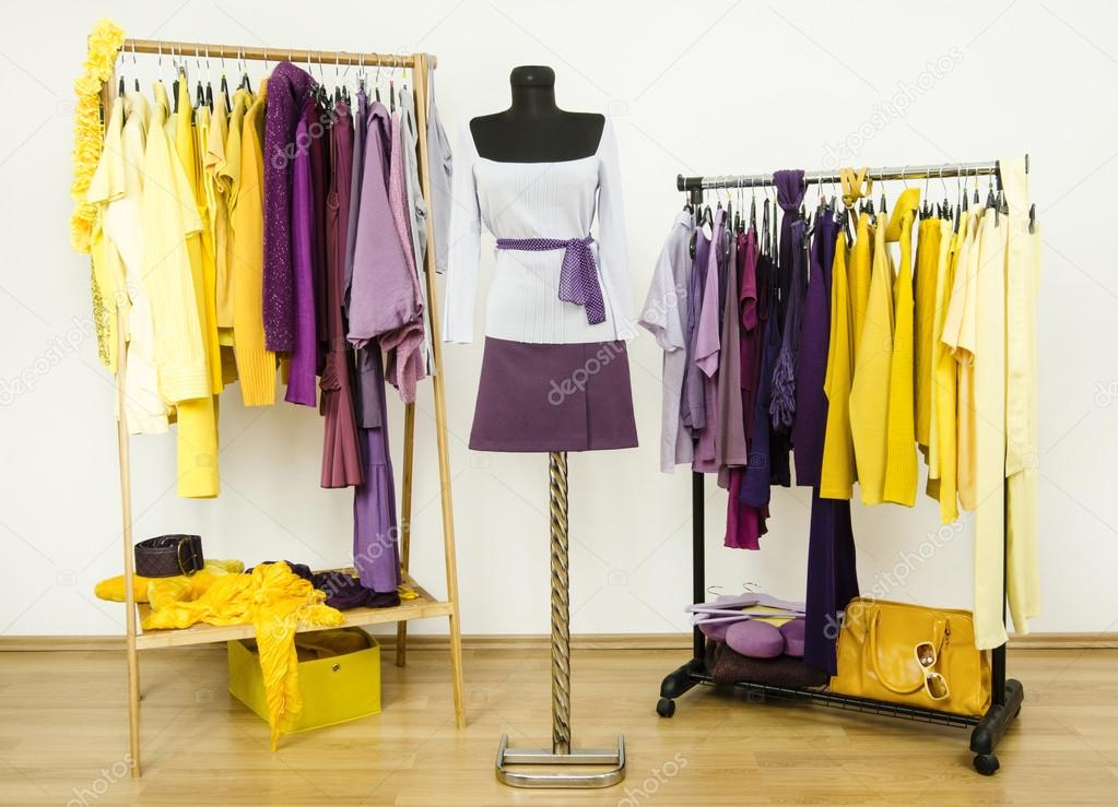 Dressing closet with complementary colors violet and yellow clothes.