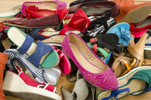 Close up on big pile of colorful woman shoes. — Stock Photo, Image