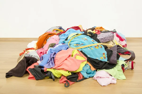 Close up on a big pile of clothes and accessories thrown on the ground. — Stock Photo, Image