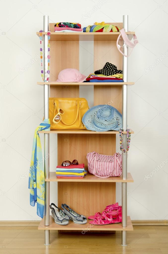 Summer clothes nicely arranged on a shelf.