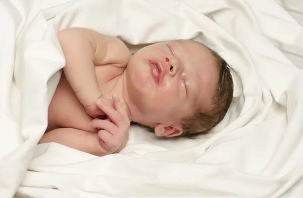 New born baby boy smiling in his sleep. — Stock Photo, Image