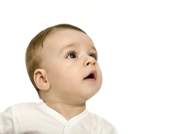 Cute baby boy looking up surprised. Stock Image