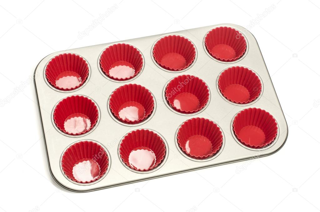 Cupcake tray with red silicone liners.