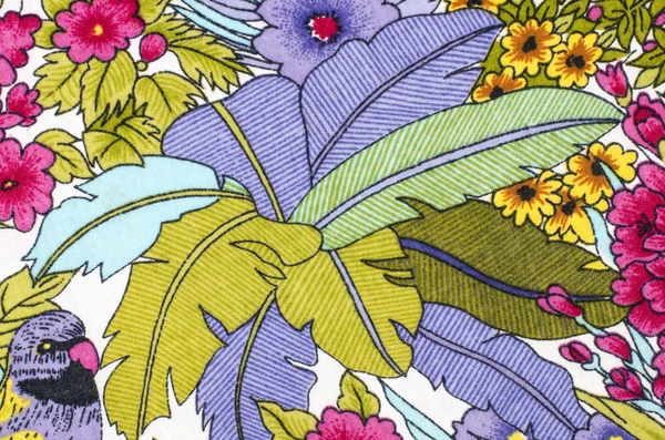 Patrón floral con un loro sobre tela . —  Fotos de Stock