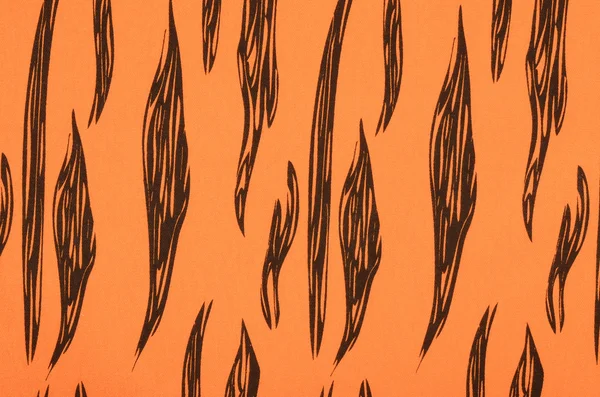 Svarta ränder på orange tyg. — Stockfoto
