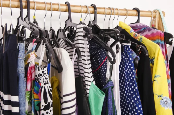 Close up on colorful clothes on hangers in a store. — Stock Photo, Image