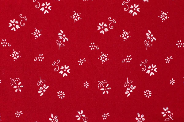 Pequeno padrão floral em tecido vermelho . — Fotografia de Stock