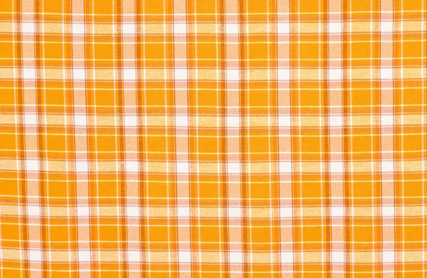 Schotse tartan patroon. Oranje met witte plaid afdrukken op stof. — Stockfoto
