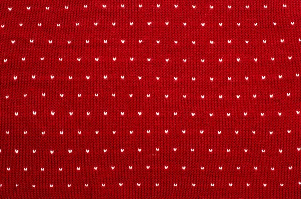 Närbild på vita och röda hjärtat prickar ylle konsistens. — Stockfoto