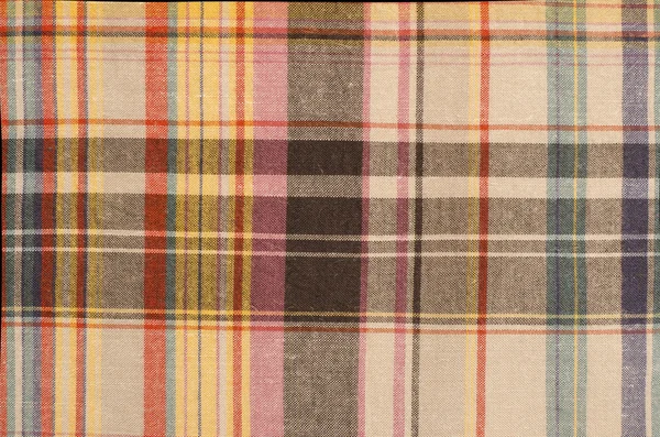 Scottish tartan pattern. Orange and brown with yellow plaid print as background.