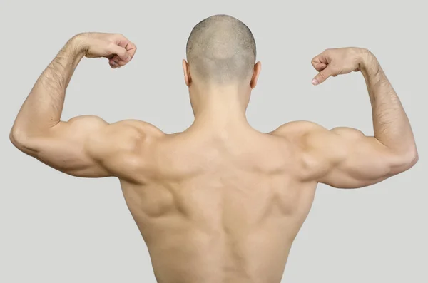 Topless man from the back raising his arms and fists. — Stock Photo, Image