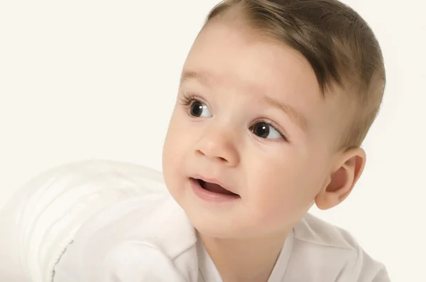 Lindo bebé mirando hacia un lado . — Foto de Stock