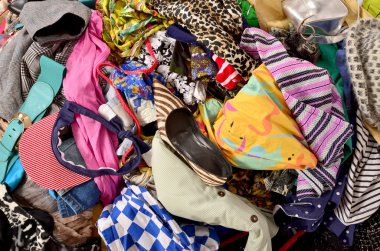 Close up on a big pile of clothes and accessories thrown on the clipart