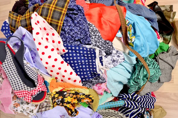 Close up on a big pile of clothes and accessories thrown on the — Stock Photo, Image