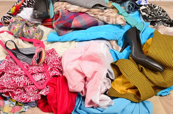 Close up on a big pile of clothes and accessories thrown on the — Stock Photo, Image