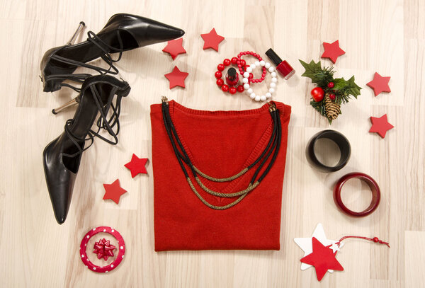Winter Christmas sweater with accessories arranged on the floor.