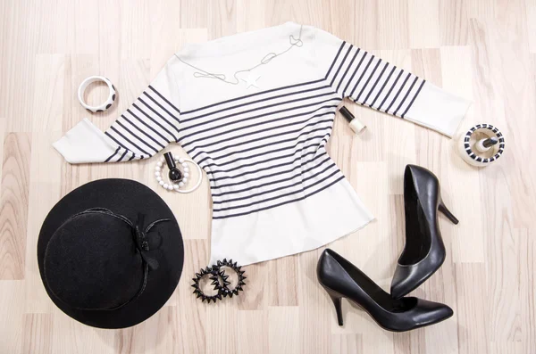 Striped blouse with accessories arranged on the floor. — Stock Photo, Image