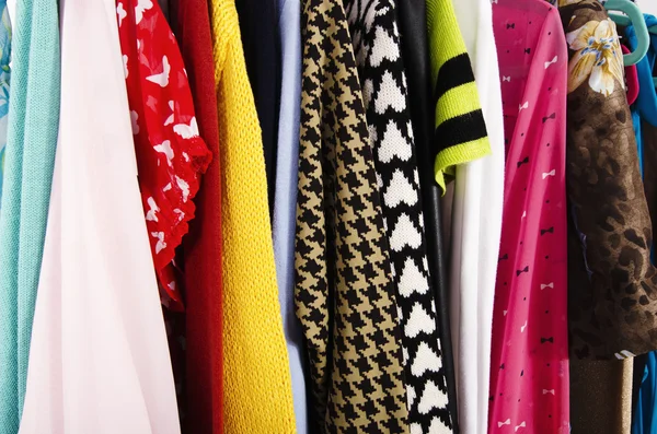 Close up on colorful clothes on hangers in a store. — Stock Photo, Image