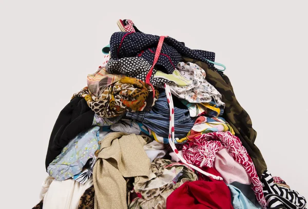 Close up on a big pile of clothes and accessories thrown on the floor. — Stock Photo, Image