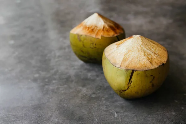 The young coconut is tasty for drinking juice on stone background