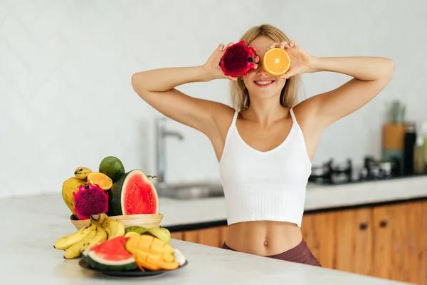 Mulher sorrindo com uma fruta tropical — Fotografia de Stock