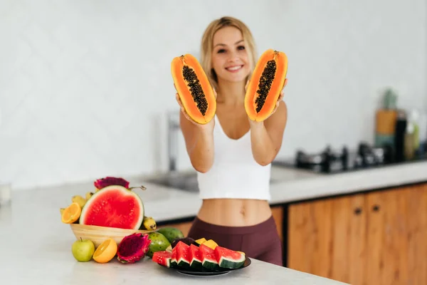 Mulher sorrindo com uma fruta tropical — Fotografia de Stock