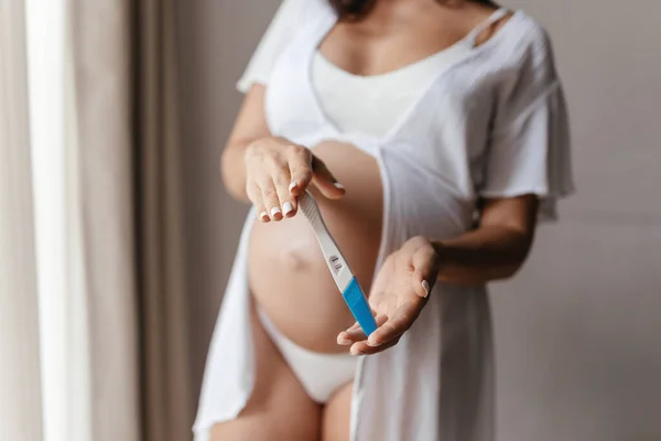 Woman holding pregnancy test, New life and new family concept.