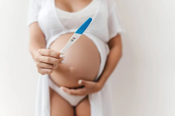 Woman holding pregnancy test, New life and new family concept.