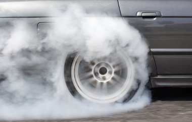 Drag racing car burning tire for the race clipart