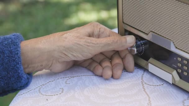 Senior Mão Mulher Girando Botão Rádio Vintage Quintal — Vídeo de Stock