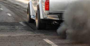 air pollution crisis in city from diesel vehicle exhaust pipe on road clipart