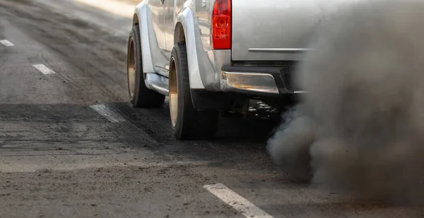 air pollution crisis in city from diesel vehicle exhaust pipe on road