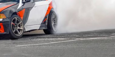 Race drift car burning tires on speed track clipart