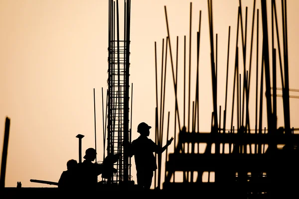 Construction worker silhouette on the work place — Stock Photo, Image